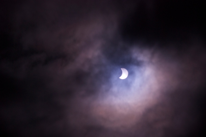 The partial eclipse through the clouds.
